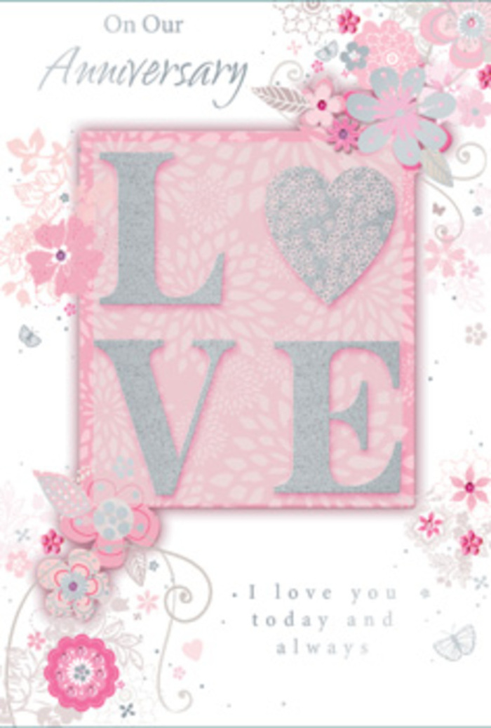 Captured as though on a neatly laid table in a cosy Eastcote home, this anniversary card evokes the warmth of a well-chosen bouquet, translated into paper. At its heart is the bold word LOVE, each letter raised and coated with a soft, glitter-kissed texture that looks almost velvety and would feel gently grainy under exploring fingertips. The letters sit upon a blush pink rectangular panel, its edges subtly softened, as if lit by the ambient glow of late-afternoon light filtering through nearby garden trees. Around this central motif, a cascade of drawn flowers and curling foliage flows outward in sweeping arcs, their lines so delicate and intentional that they resemble the pencil marks a florist might sketch when planning a romantic anniversary design at Florist Eastcote. Petals in powdery blush, pearlescent white, and muted grey are shaded with a near-watercolour softness, suggesting the fragile beauty of fresh blooms that might have just arrived from market. Leaves and tendrils weave between the flowers, looping gracefully like vines climbing an old brick wall near Eastcote's quiet residential streets. Glints of silver and subtle glitter tucked among the petals hint at dewdrops catching the morning sun, adding a refined shimmer without overwhelming the soft, romantic mood. The background is a smooth wash of pale pink that deepens slightly behind the central word, creating gentle depth and guiding the eye toward the message. In an elegant, flowing script, a heartfelt anniversary greeting nestles beside the floral motif, its rounded letters echoing the card's curves and swirls. The overall effect is serene and affectionate, much like receiving a hand-tied anniversary bouquet: a tender, thoughtfully arranged celebration of commitment and enduring love.