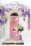 This image captures a doorway that feels like a gentle embrace, the kind of entrance you might discover while wandering through the quieter corners of Eastcote as evening light settles softly on the houses. The front door is painted a tender, powder-pink, its surface matte and calm against the whitewashed façade, with a matching shutter adding balance and charm. Overhead, luxuriant strands of wisteria pour down in cascades of lavender and soft lilac, the flower clusters dense yet delicate, forming a natural archway that frames the door in romantic colour. Each hanging bloom suggests the faint, sweet scent often found in established Eastcote gardens, particularly in spring when driveways and front paths are at their prettiest. At the threshold, on the smooth, pale step, stands a grey tin florist's bucket-simple, functional, and full of character. It is generously packed with white and cream roses, their lush, full-blown heads leaning gently in different directions as if they are quietly greeting whoever approaches. Between the roses, subtle sprigs of green foliage weave in and out, adding shape, freshness, and a gentle contrast that enhances the pastel scheme rather than disturbing it. A soft pink ribbon circles the bucket, tied in a relaxed bow whose tails spill slightly onto the step, mirroring the wisteria's cascading lines above. The light in the scene is warm but not harsh, as though filtered through nearby trees or terraced houses, creating slender shadows and catching the delicate edges of each petal. Nothing here feels rushed; instead, the arrangement suggests the careful work of a local florist, perhaps from Florist Eastcote, preparing a housewarming gift for same-day delivery to mark the first walk up these steps. The overall impression is one of tenderness, optimism, and a quietly spoken but enduring welcome home.